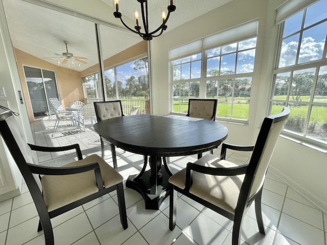 sunroom featuring ceiling fan with notable chandelier