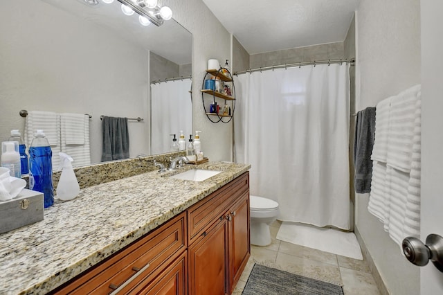 bathroom with tile patterned floors, vanity, and toilet