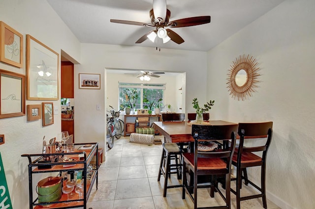 dining room with light tile patterned floors and ceiling fan