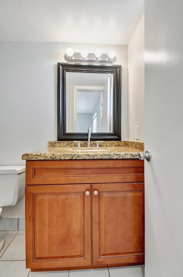 bathroom with tile patterned floors, vanity, and toilet