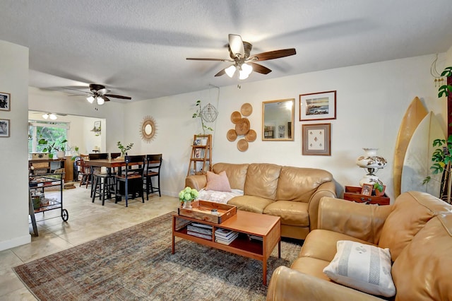 living room with light tile patterned floors, a textured ceiling, and ceiling fan