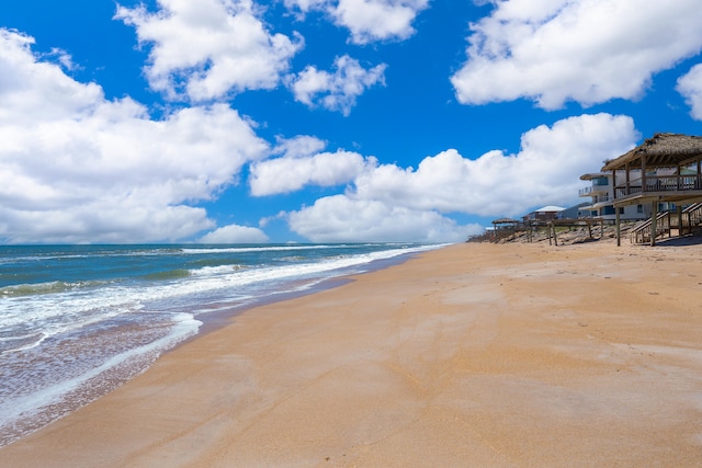 property view of water featuring a view of the beach and a gazebo