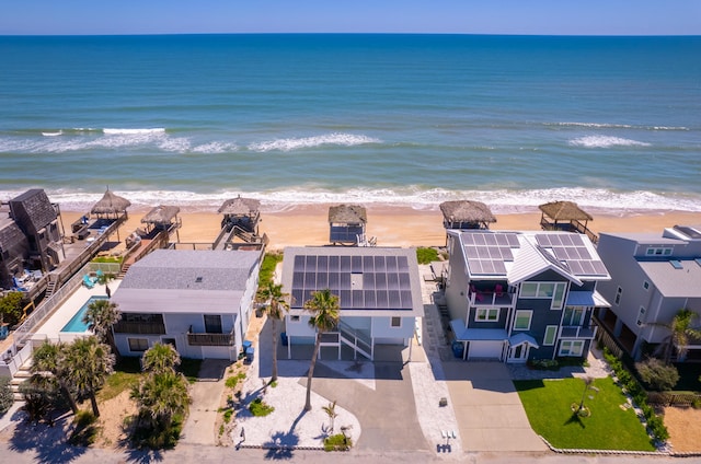 birds eye view of property featuring a beach view and a water view