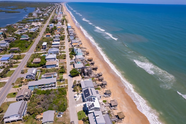 drone / aerial view with a water view and a view of the beach