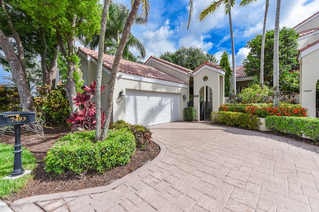 mediterranean / spanish-style home featuring a garage