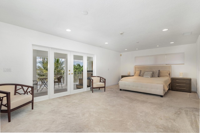 bedroom with recessed lighting, light colored carpet, visible vents, access to outside, and french doors