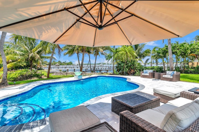 view of swimming pool featuring a patio area, fence, an outdoor living space, and a fenced in pool