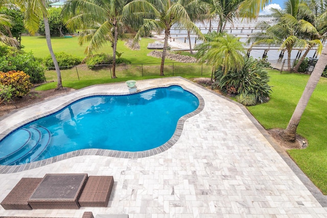 view of pool with a fenced backyard, a fenced in pool, a patio, and a yard