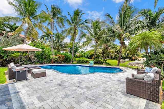 pool featuring a patio and an outdoor fire pit