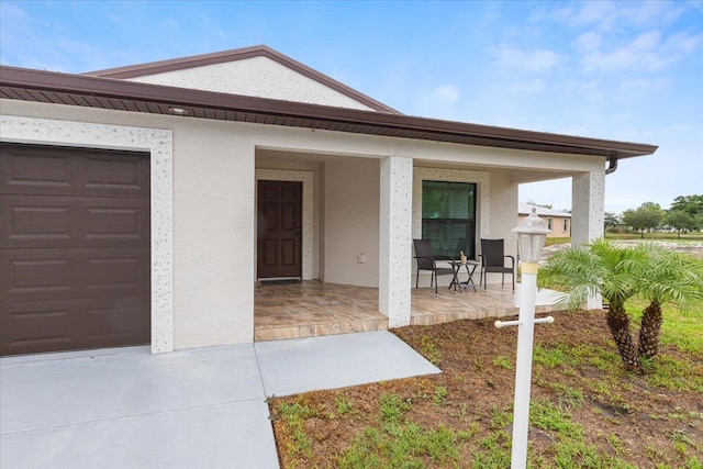 2 Tosca, Fort Pierce, FL 34951 - view of front facade with covered porch and a garage