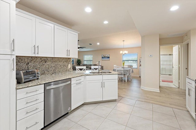 kitchen featuring white cabinets, dishwasher, kitchen peninsula, and sink