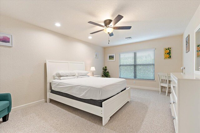 bedroom featuring ceiling fan and light carpet