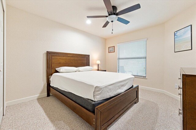 carpeted bedroom featuring ceiling fan