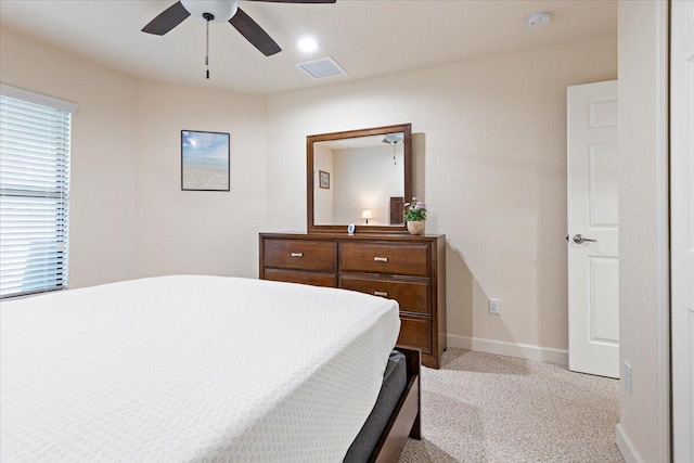 bedroom with ceiling fan and light carpet