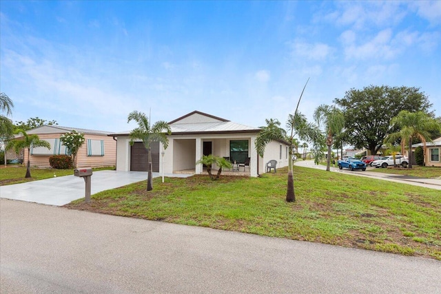 ranch-style home with a front yard and a garage