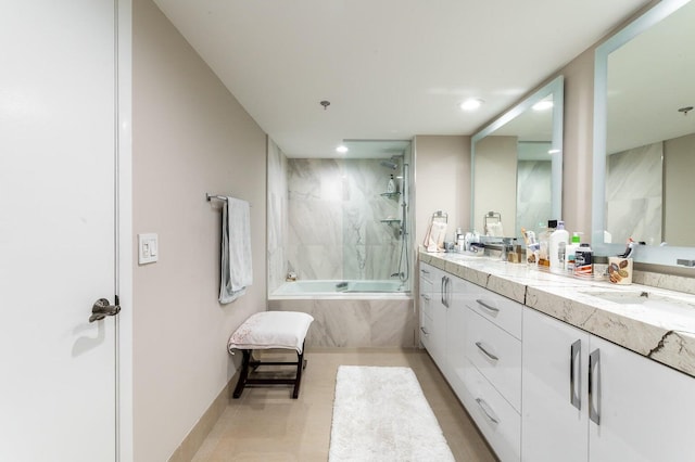 bathroom with tile floors, double sink vanity, and tiled shower / bath combo