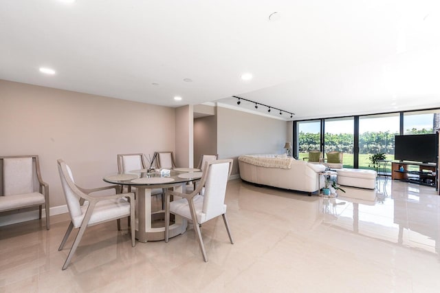 tiled dining room featuring rail lighting