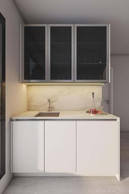 bar with light hardwood / wood-style floors, sink, and white cabinets