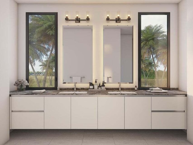 bathroom with a wealth of natural light, dual bowl vanity, and tile floors