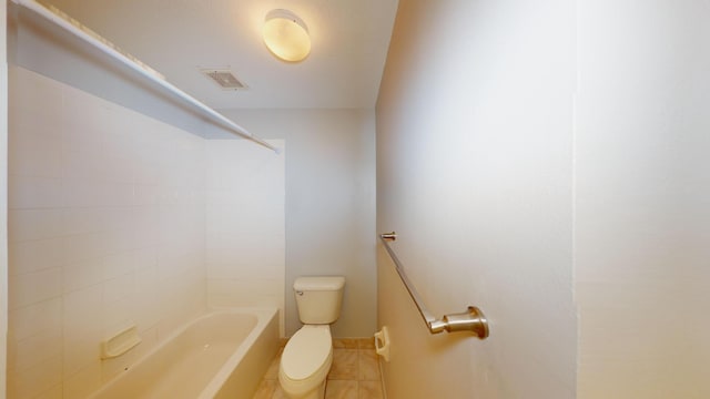 bathroom featuring toilet, tile patterned flooring, and tub / shower combination