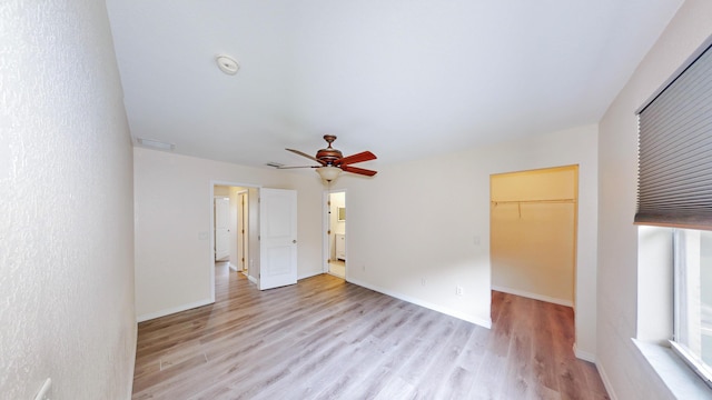 unfurnished room featuring ceiling fan and light hardwood / wood-style flooring