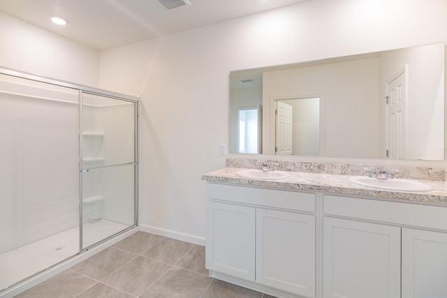 bathroom featuring vanity, tile patterned floors, and walk in shower