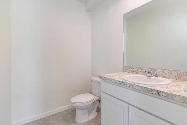 bathroom with tile patterned floors, vanity, and toilet