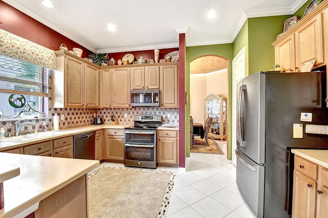 kitchen featuring appliances with stainless steel finishes, light tile patterned flooring, a wealth of natural light, and light brown cabinets