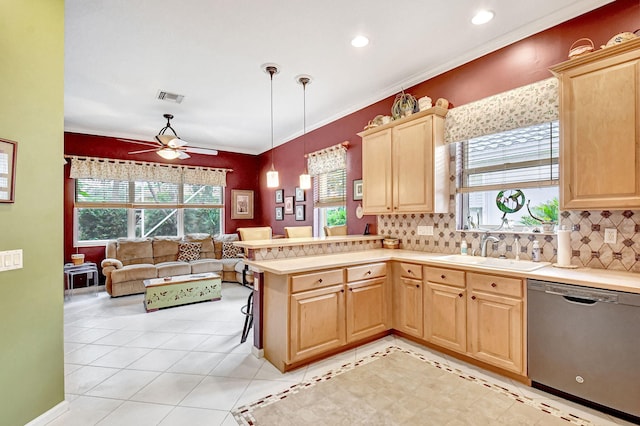 kitchen featuring dishwasher, hanging light fixtures, kitchen peninsula, sink, and backsplash