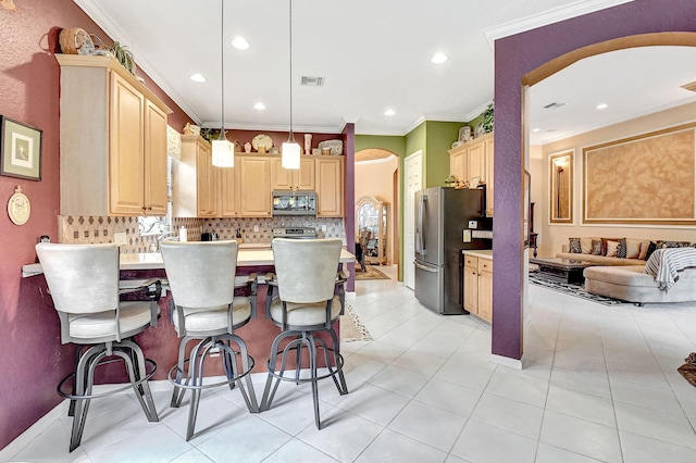 kitchen featuring ornamental molding, tasteful backsplash, light brown cabinetry, pendant lighting, and appliances with stainless steel finishes