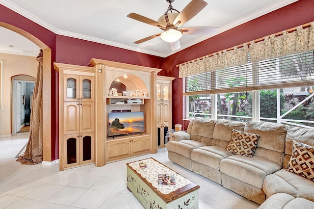 tiled living room with ceiling fan and ornamental molding