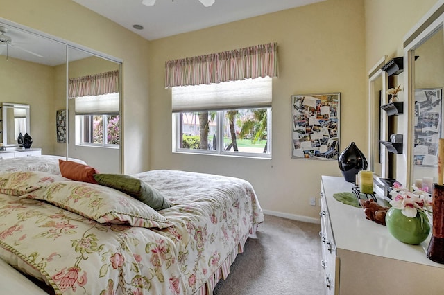 carpeted bedroom with ceiling fan and a closet