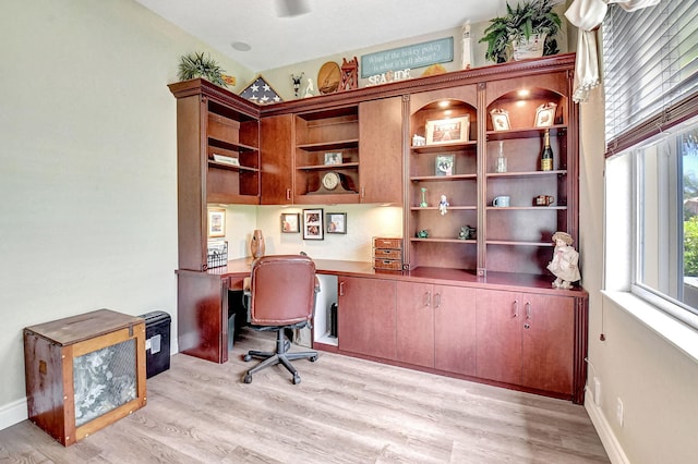 office featuring built in desk and light hardwood / wood-style flooring