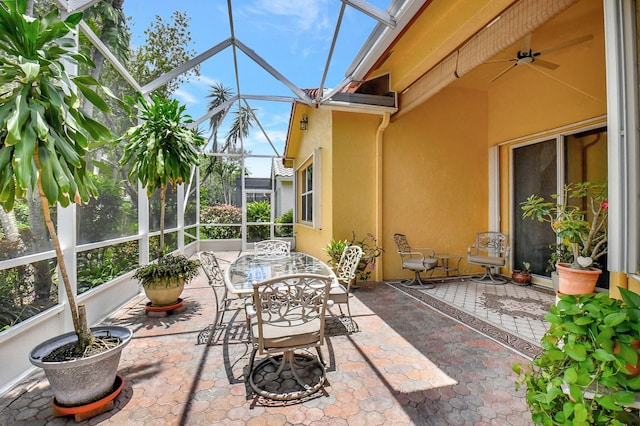 sunroom / solarium featuring ceiling fan and plenty of natural light