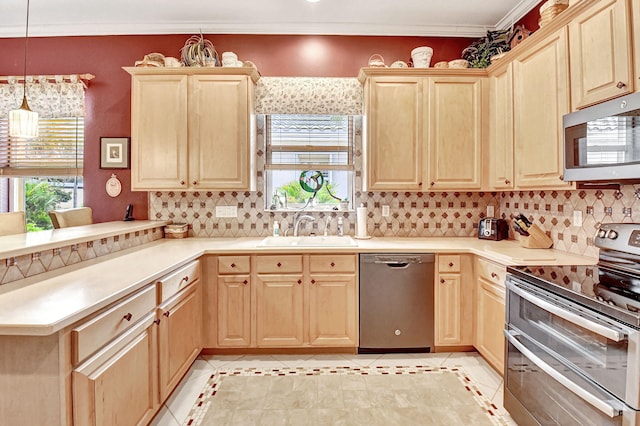 kitchen featuring sink, appliances with stainless steel finishes, light tile patterned flooring, and hanging light fixtures