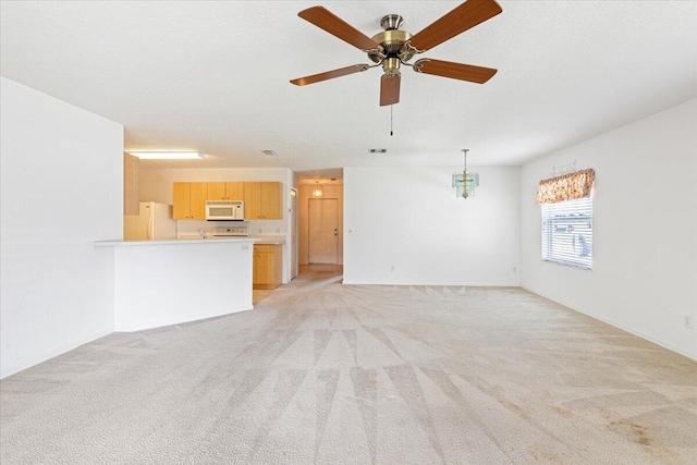 unfurnished living room with light carpet, a textured ceiling, and ceiling fan