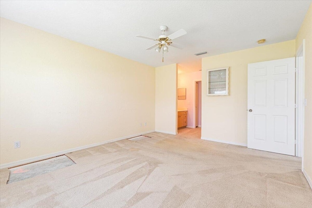 carpeted empty room featuring a textured ceiling and ceiling fan