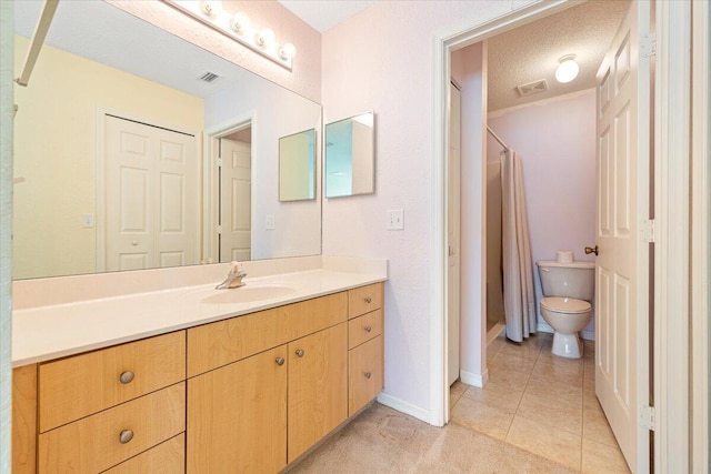 bathroom featuring tile patterned flooring, vanity, walk in shower, toilet, and a textured ceiling