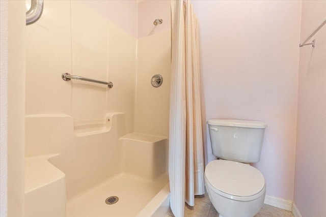 bathroom with tile patterned flooring, toilet, and a shower with shower curtain