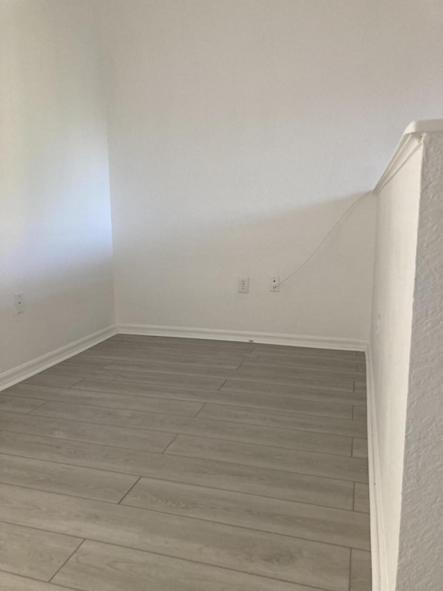 spare room with hardwood / wood-style flooring