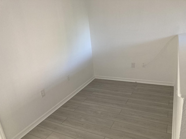 unfurnished room with wood-type flooring