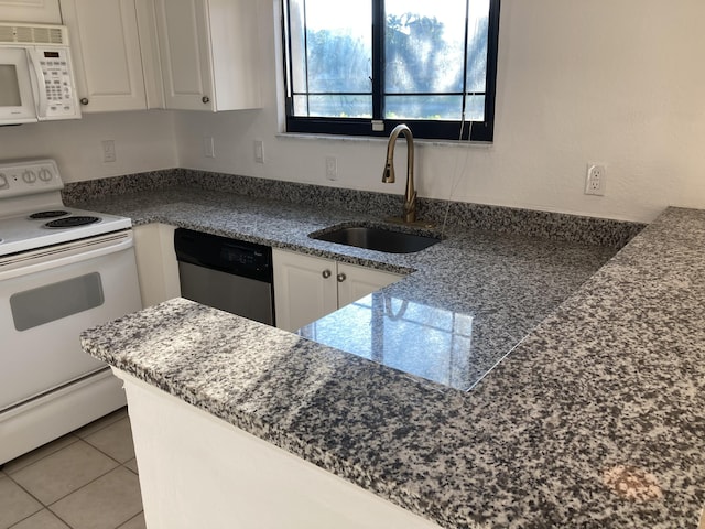 kitchen featuring white appliances, white cabinets, sink, and light tile patterned floors