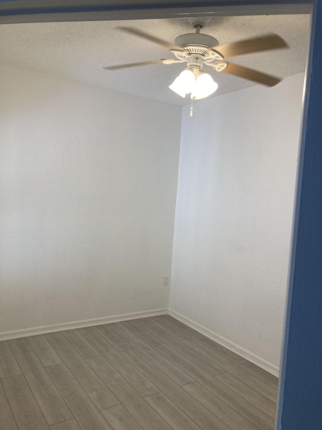 spare room featuring hardwood / wood-style flooring and ceiling fan