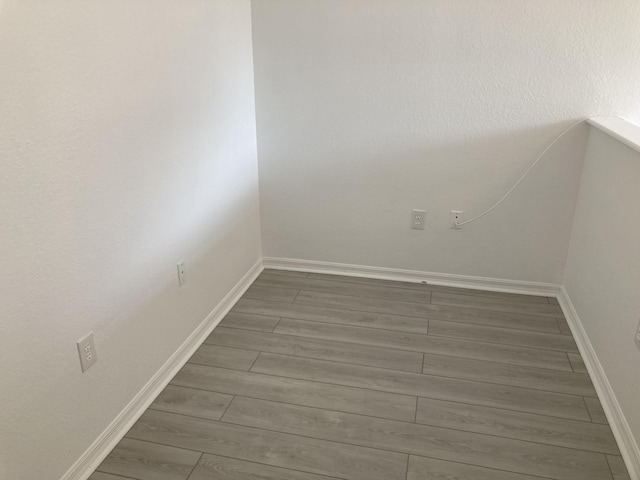 spare room featuring wood-type flooring