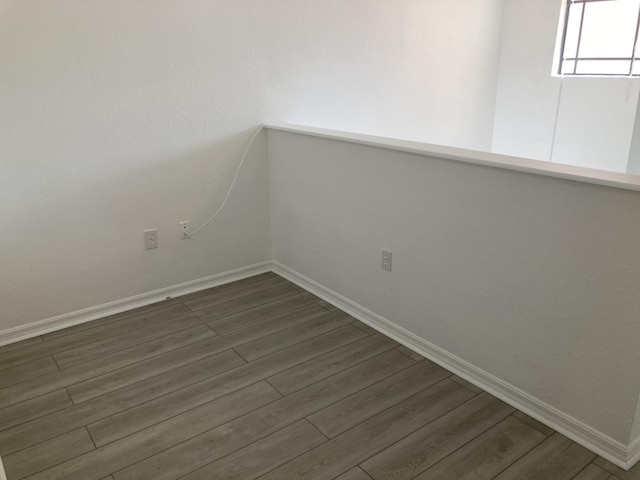 unfurnished room featuring dark hardwood / wood-style flooring