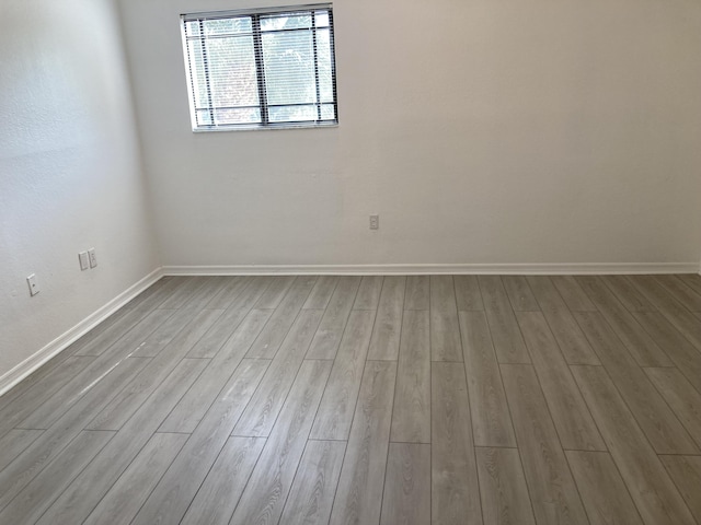 spare room with light hardwood / wood-style flooring