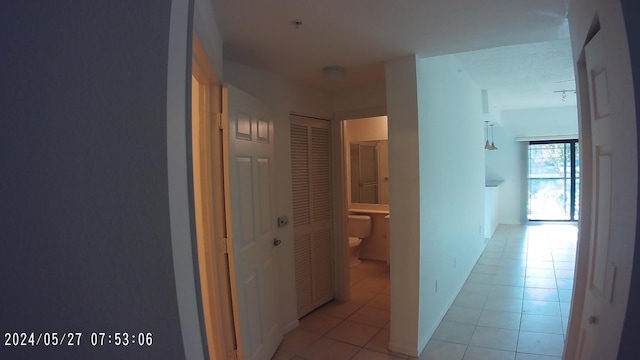 hallway with light tile patterned floors