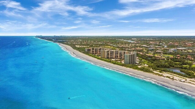 birds eye view of property featuring a beach view and a water view