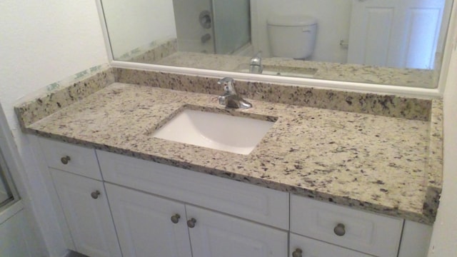 bathroom with toilet and vanity