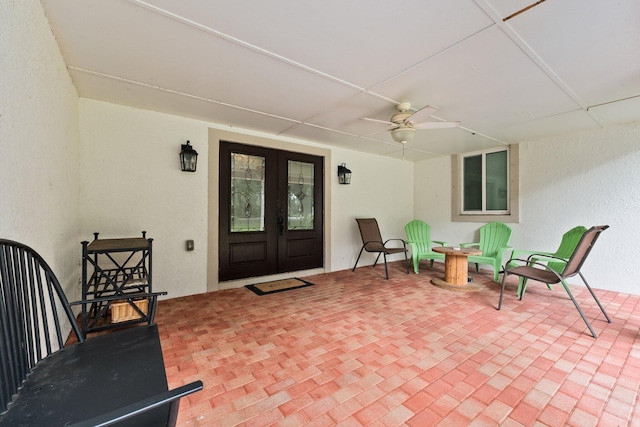 view of exterior entry with ceiling fan and french doors